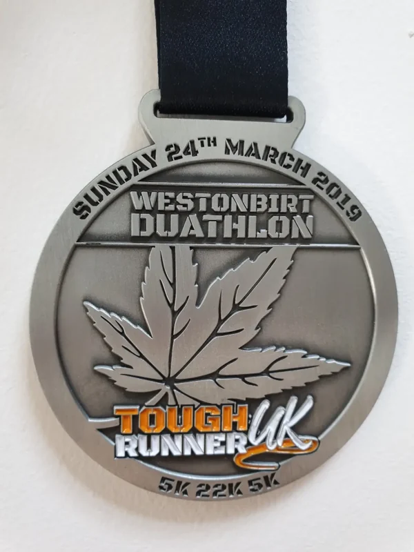 Westonbirt Duathlon custom medal with raised leaf design